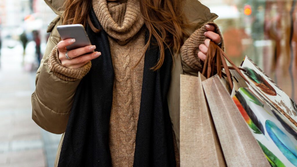 A woman searching on her phone during a holiday season