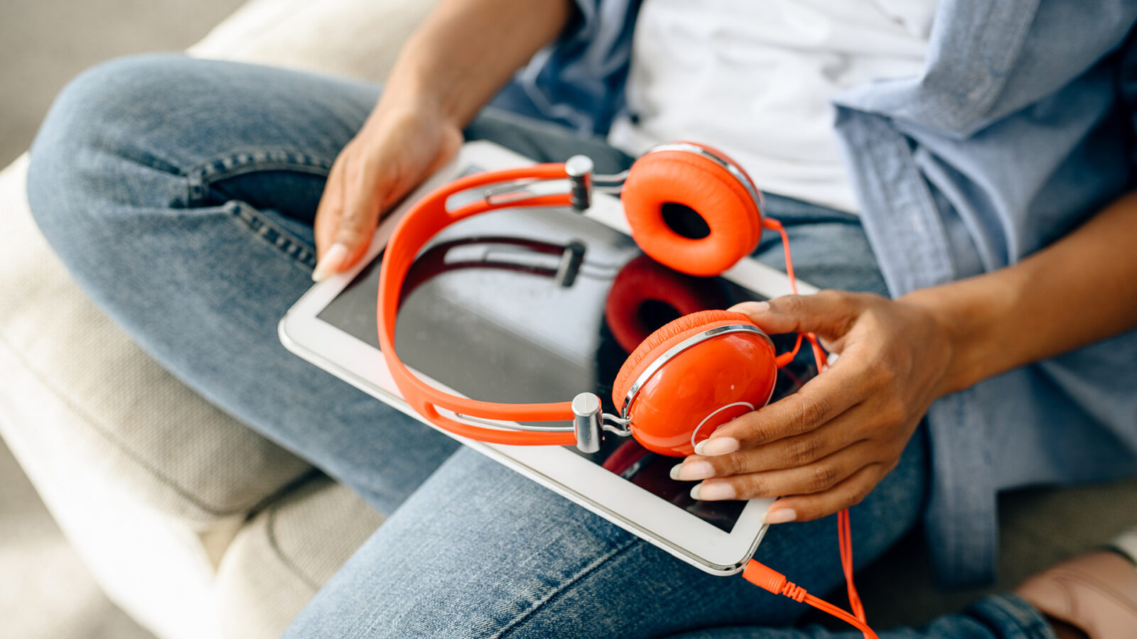 a man with headphones about to listen to a podcast with advertising following a podcast strategy