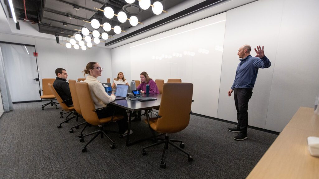 An integrated marketing team working in a conference room.