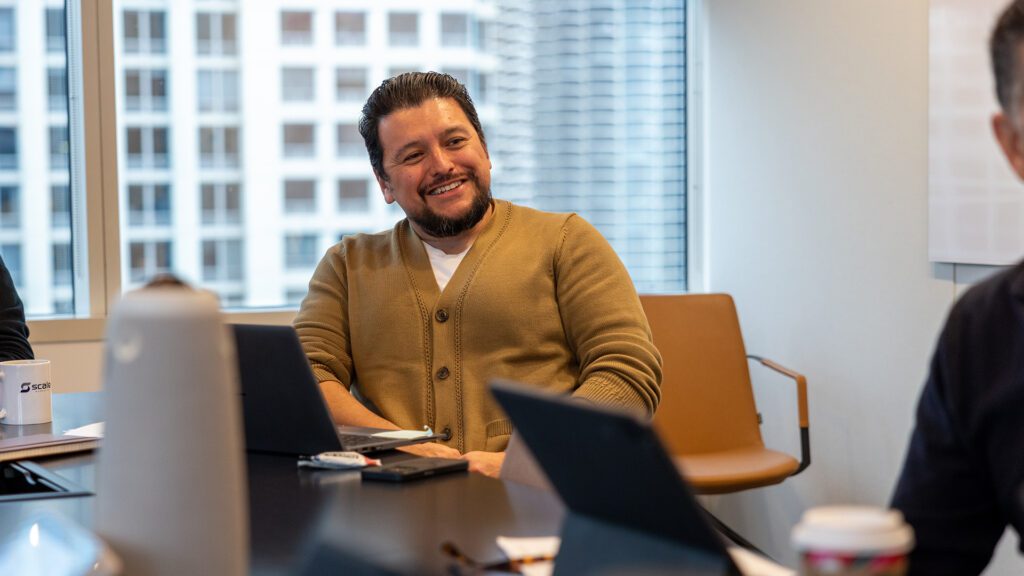 A marketing employee smiles in a conference room