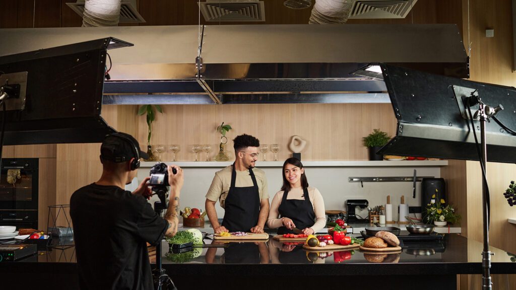 Actors work on the set of a food blog video production