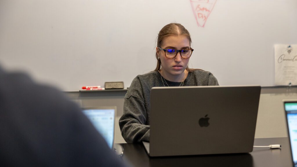 A marketing team member works on a Meta ad strategy